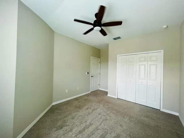 a view of a big room with carpet