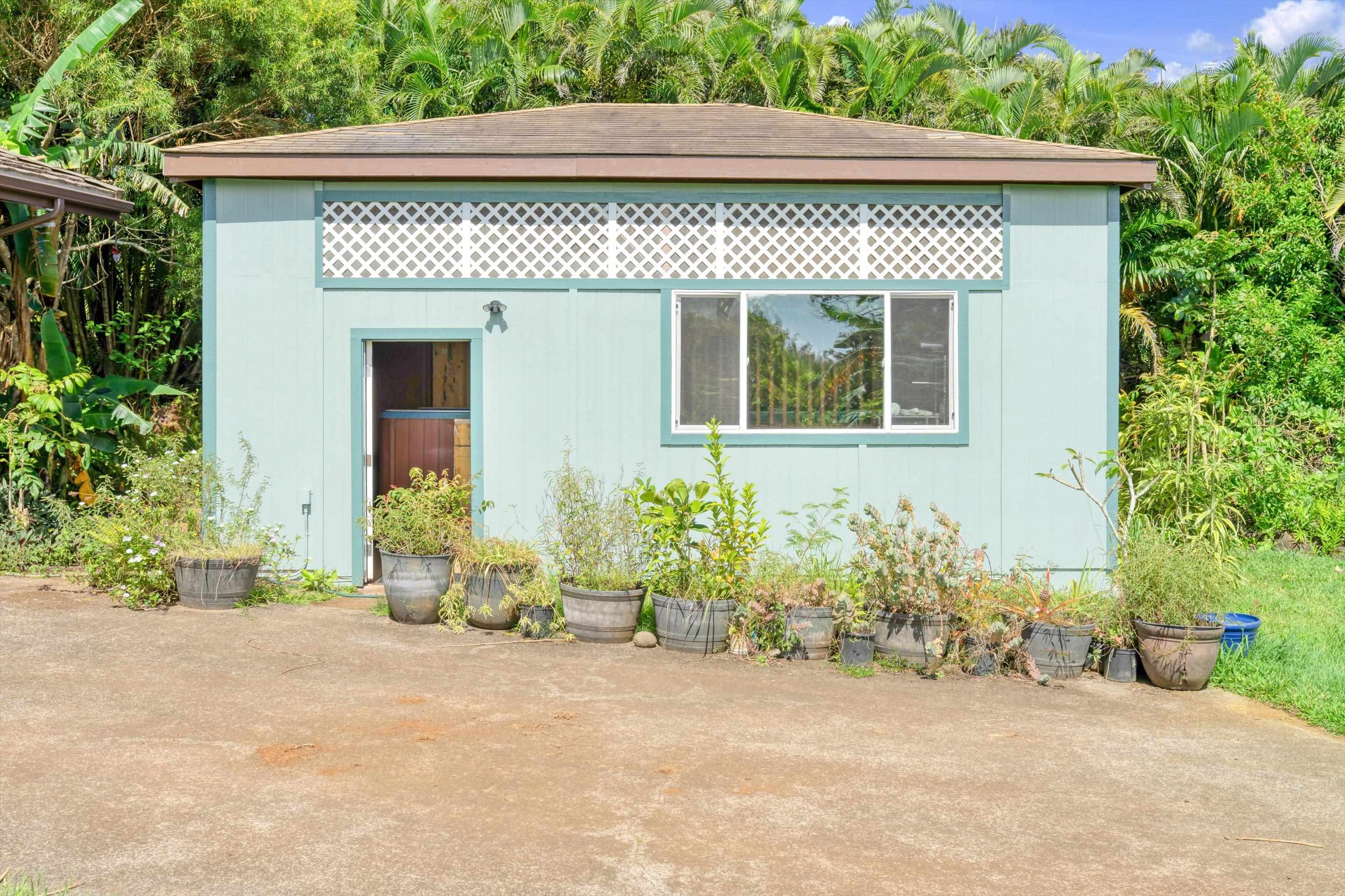 145 South Holokai Road Haiku, HI 96708 - Photo 45 of 50 a front view of a house with a yard and garage