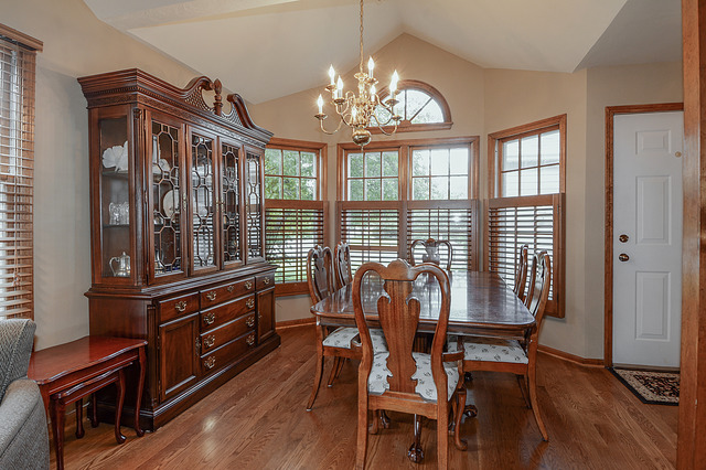 2570 Miller Road Geneva, IL 60134 - Photo 4 of 21 a view of a dining room with furniture a chandelier and wooden floor