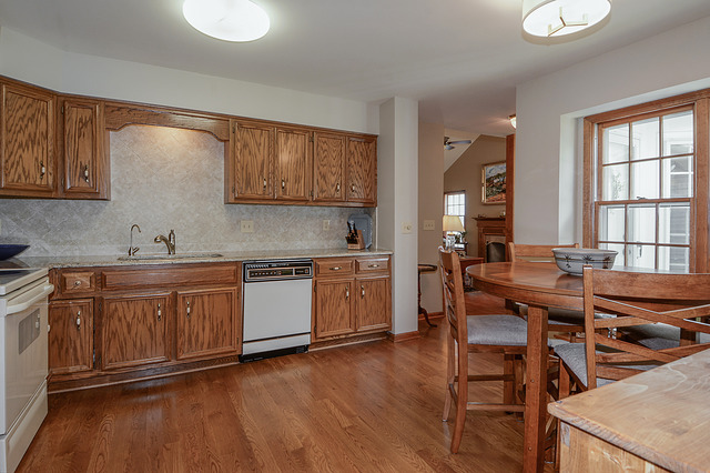 2570 Miller Road Geneva, IL 60134 - Photo 5 of 21 a kitchen with a sink cabinets and wooden floor