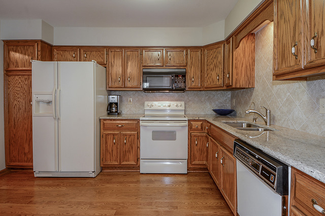 2570 Miller Road Geneva, IL 60134 - Photo 6 of 21 a kitchen with stainless steel appliances granite countertop a refrigerator stove a sink and dishwasher with wooden cabinet