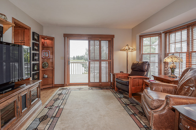 2570 Miller Road Geneva, IL 60134 - Photo 9 of 21 a living room with furniture a flat screen tv and large windows