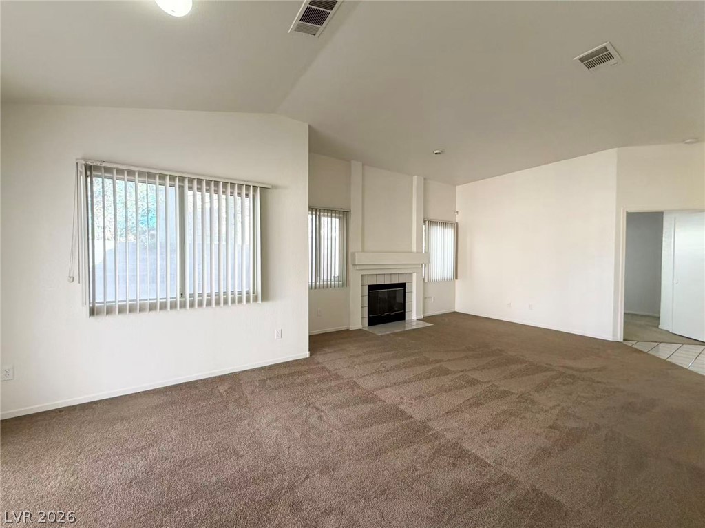 8620 Magnolia Ridge Avenue Las Vegas, NV 89134 - Photo 2 of 15 A spacious living area with a cozy fireplace provides a comfortable gathering space.
