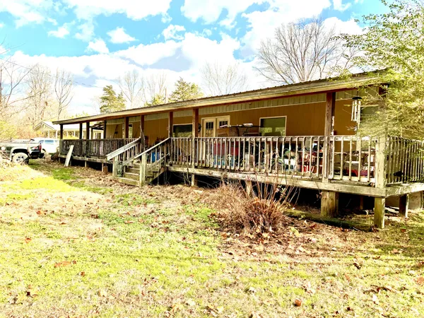 a view of a house with pool and sitting area