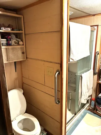 a bathroom with a toilet a sink and a shower