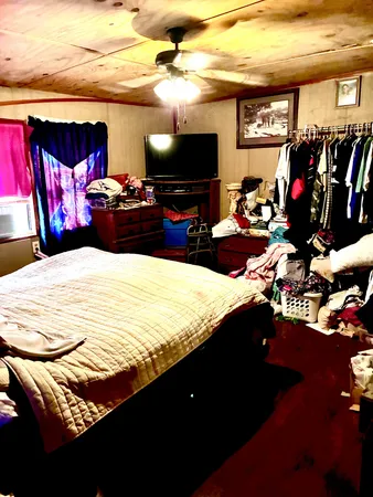 a bedroom with a bed and a flat screen tv