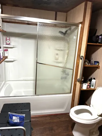 a bathroom with a toilet and a shower
