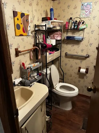 a bathroom with a sink a toilet and a mirror