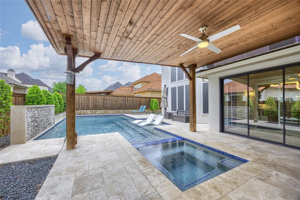918 Sydney Lane Allen, TX 75013 - Photo 34 of 40 The property features an outdoor pool with an integrated spa, complemented by a covered patio with a ceiling fan