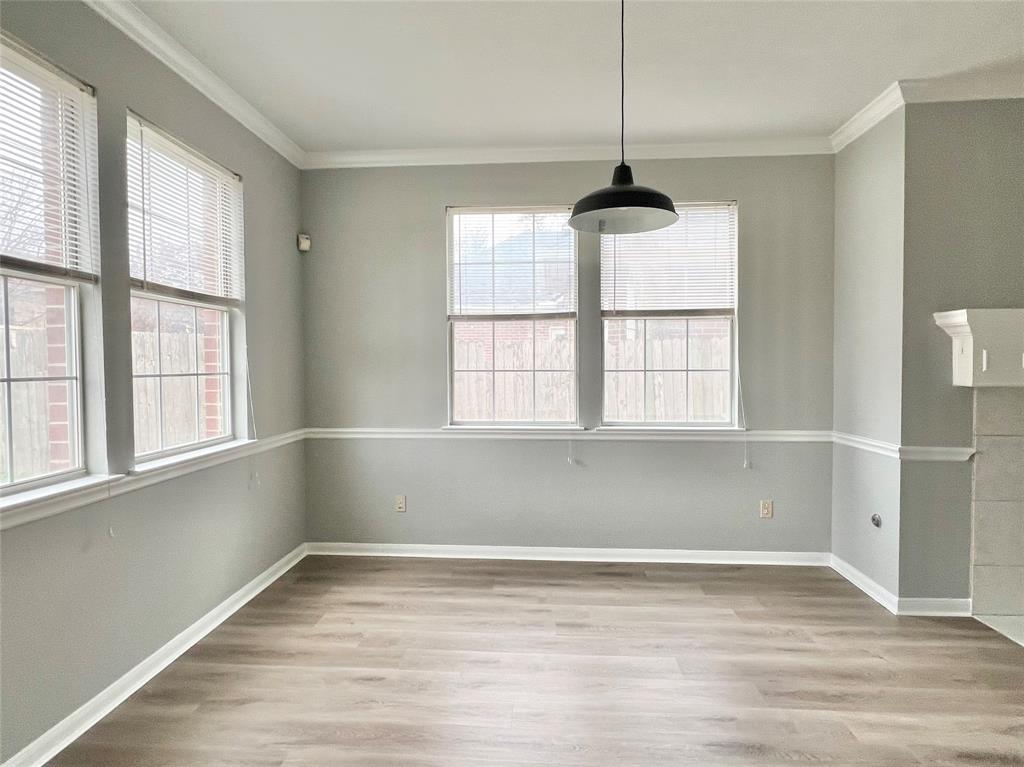 1809 Springwater Drive Round Rock, TX 78681 - Photo 4 of 25 Unfurnished dining area with light wood finished floors and crown molding