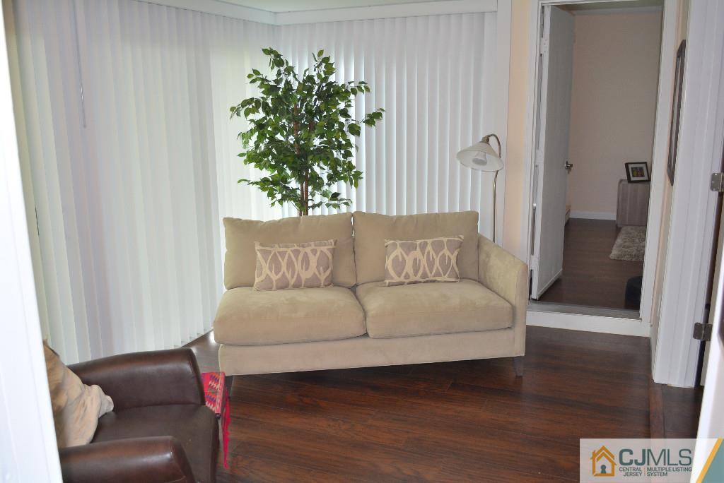 39 B Haddon Road Monroe Township, NJ 08831 - Photo 11 of 22 a living room with furniture and a potted plant