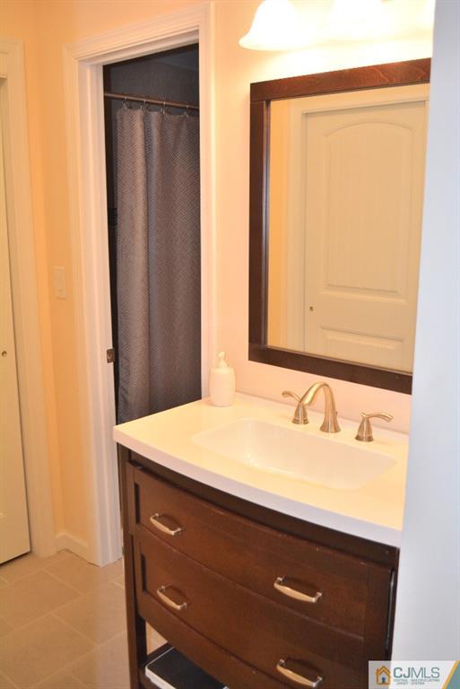 39 B Haddon Road Monroe Township, NJ 08831 - Photo 14 of 22 a bathroom with a sink and a mirror