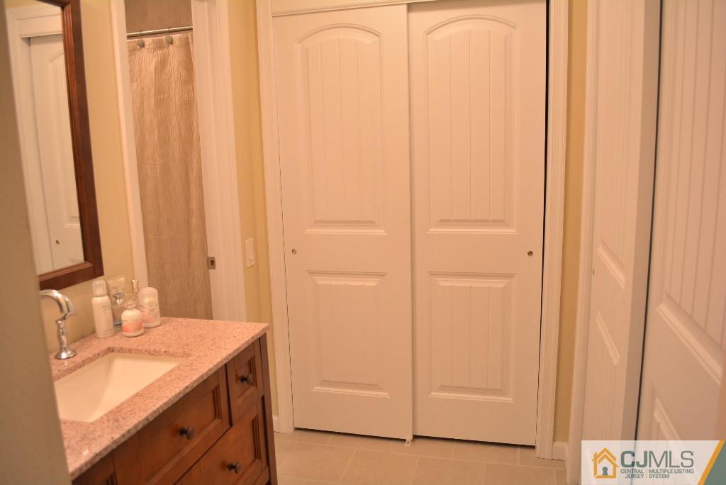 39 B Haddon Road Monroe Township, NJ 08831 - Photo 17 of 22 a bathroom with a sink and a mirror
