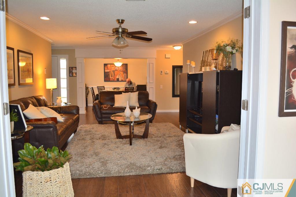 39 B Haddon Road Monroe Township, NJ 08831 - Photo 8 of 22 a living room with furniture and a chandelier