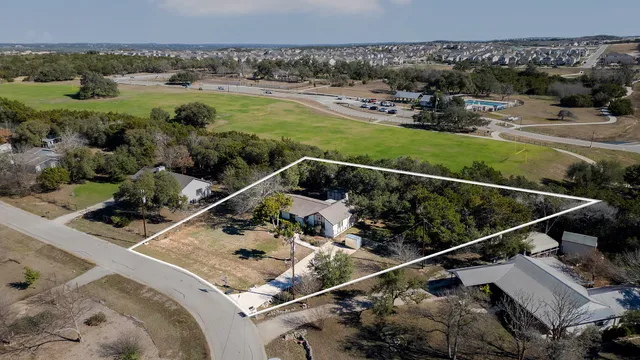 an aerial view of a house with a yard