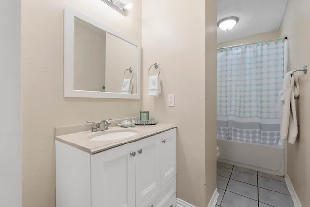 a kitchen with granite countertop a sink stainless steel appliances and cabinets