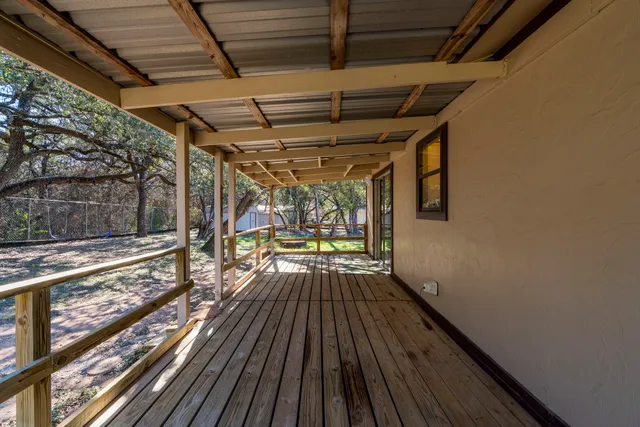 a view of a porch with wooden floor