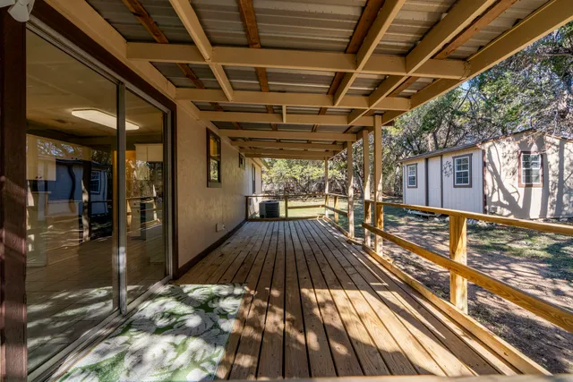 a view of a backyard with large trees