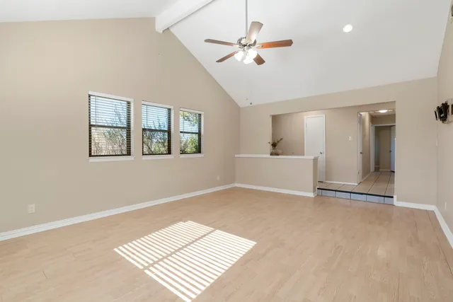 a view of a hallway to a livingroom with furniture