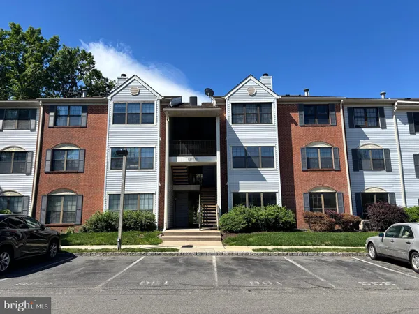 a front view of a residential apartment building with a yard