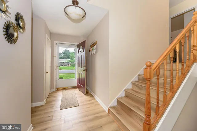 a view of entryway and hall with wooden floor