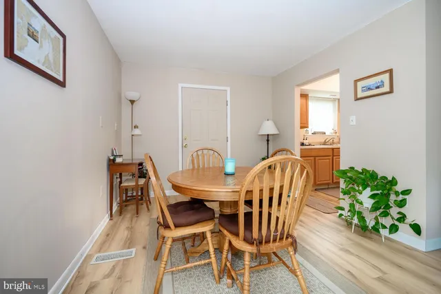 a view of a dining room with furniture and a potted plant