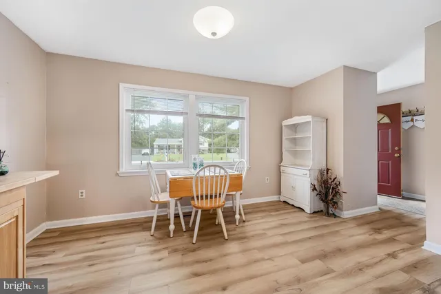 a dining room with furniture and wooden floor