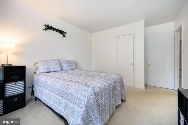 a bedroom with a bed and a lamp