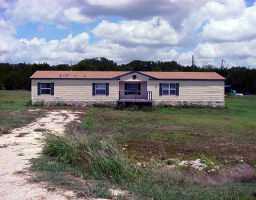 11925 Fitzhugh Road Dripping Springs, TX 78620 - Photo 1 of 1 a view of a house with a yard and fence