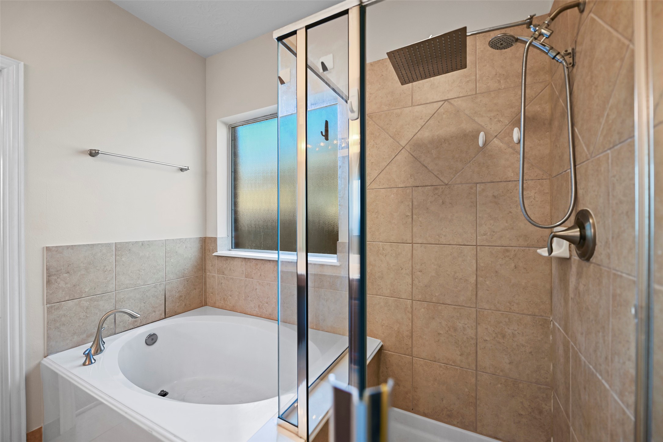 8323 Rudy Brook Way Spring, TX 77379 - Photo 18 of 35 a bathroom with a white bath tub and a shower