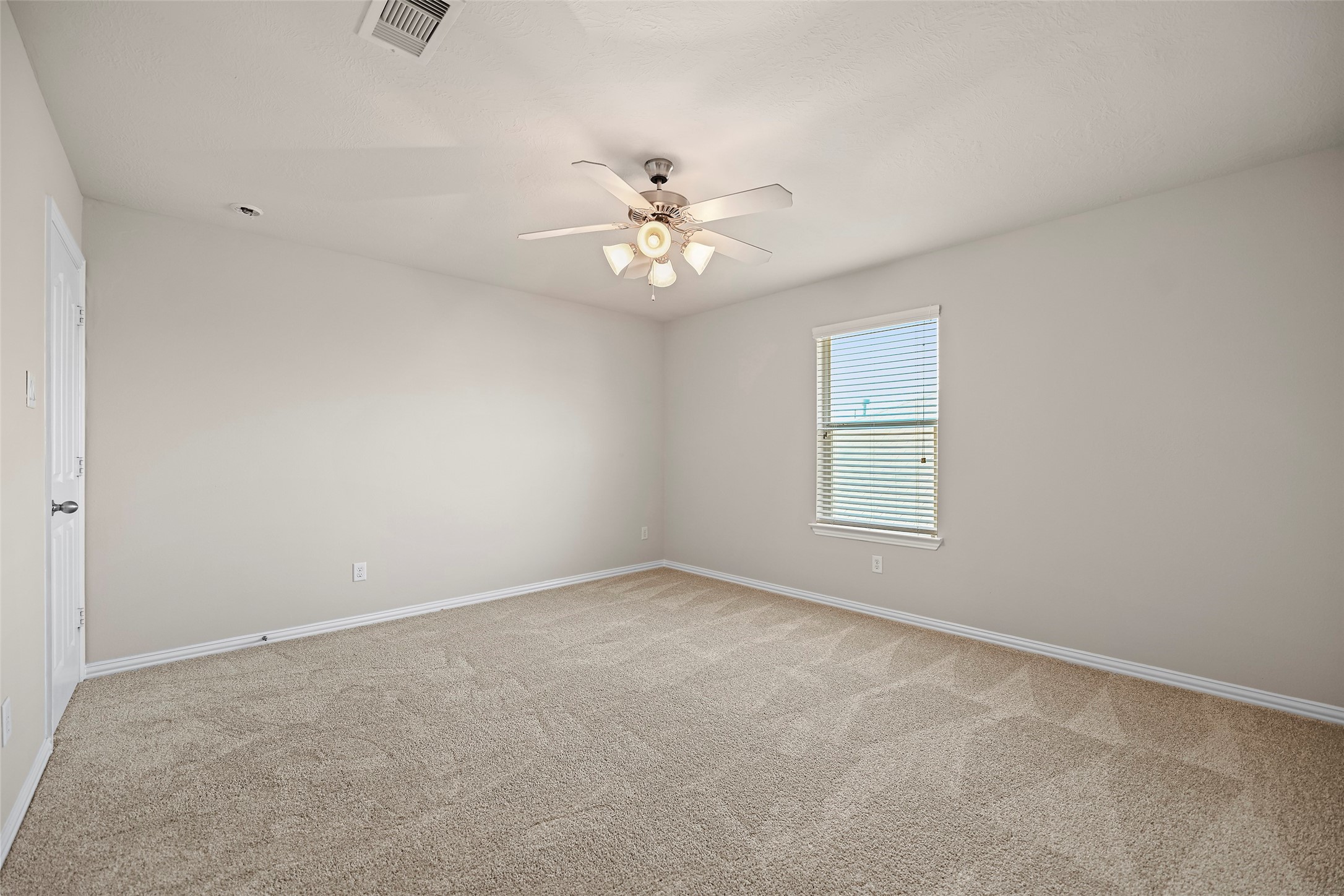 8323 Rudy Brook Way Spring, TX 77379 - Photo 25 of 35 an empty room with a window and a fan