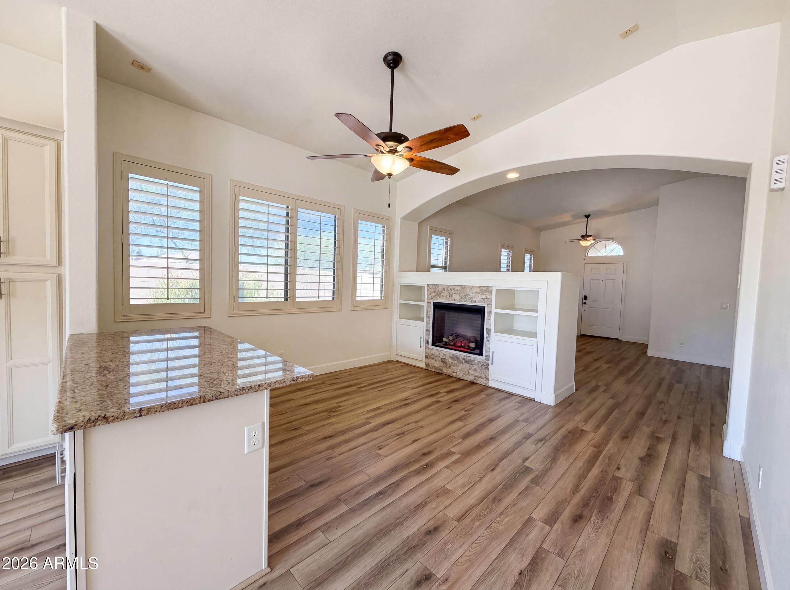 3951 East Timberline Road Gilbert, AZ 85297 - Photo 3 of 28 a view of an empty room with a fireplace and a window