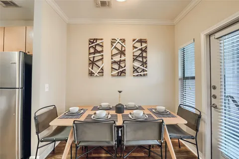 a view of a dining room that has a table and chairs in it