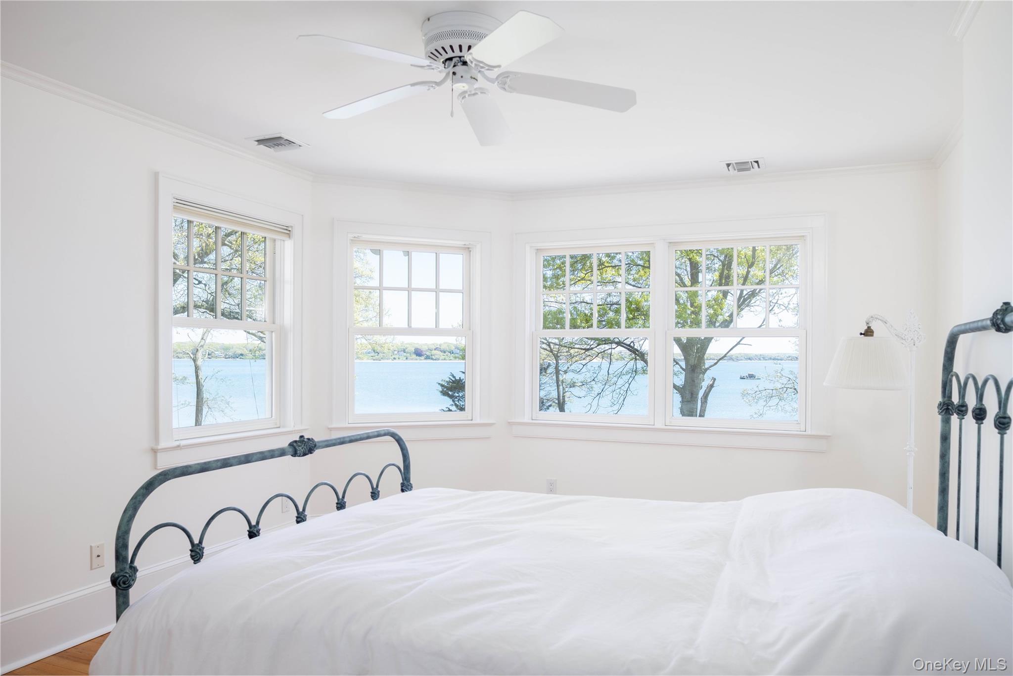 5055 New Suffolk Road New Suffolk, NY 11956 - Photo 28 of 42 a bedroom with a large bed and a window