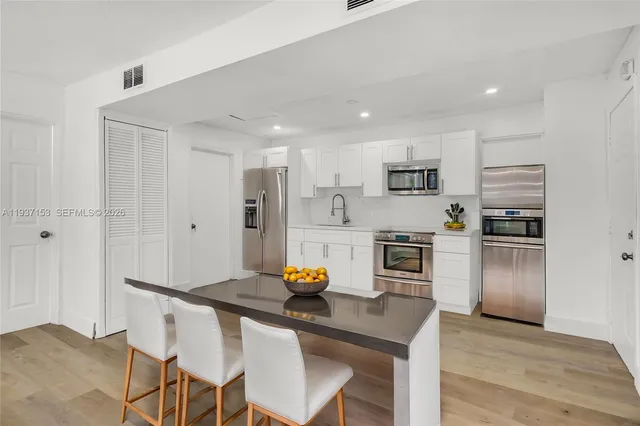 a kitchen with stainless steel appliances a refrigerator sink and stove