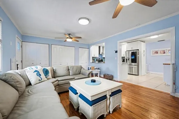 a living room with furniture and wooden floor
