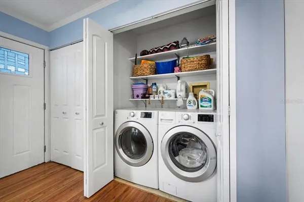 a view of walk in closet with clothes and shoes