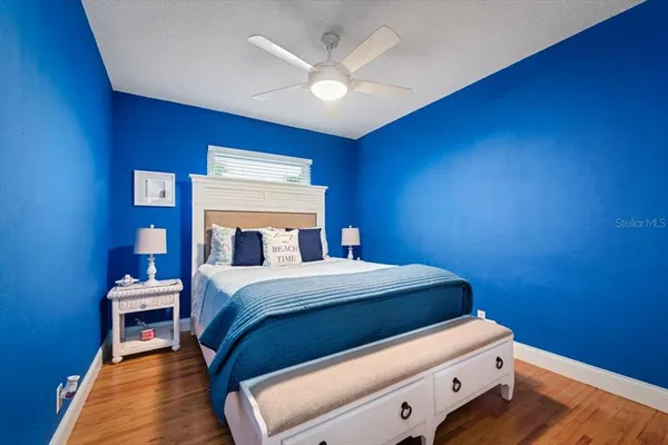 a bed room with a bed and a ceiling fan