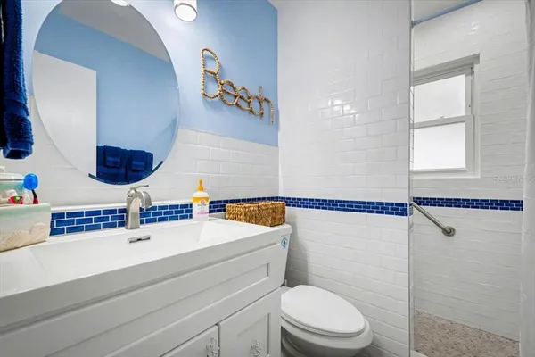 a bathroom with a sink a mirror and a shower