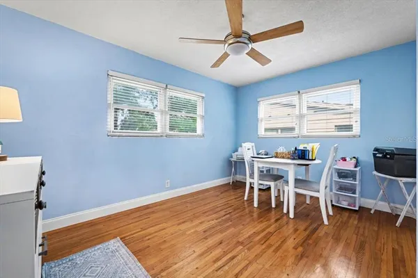 a dining room with wooden floor and a window