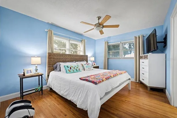 a bedroom with a bed and a flat screen tv