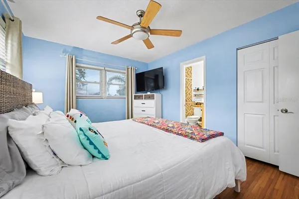 a bedroom with a bed and a flat screen tv