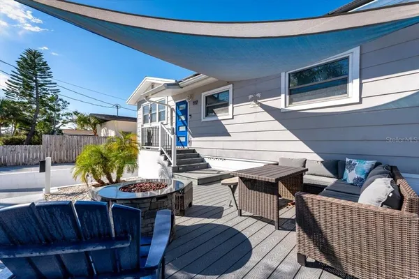 a view of a patio with table and chairs with wooden floor and fence