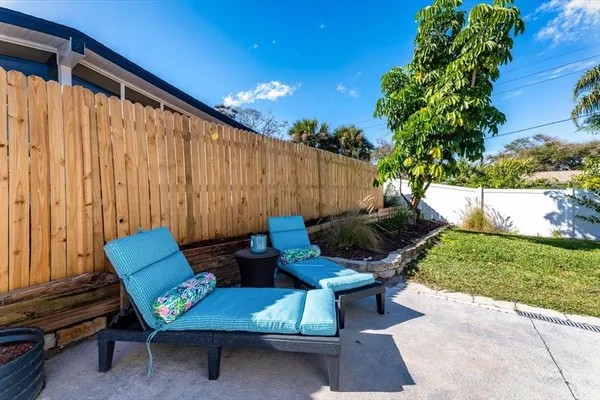 a backyard of a house with outdoor seating