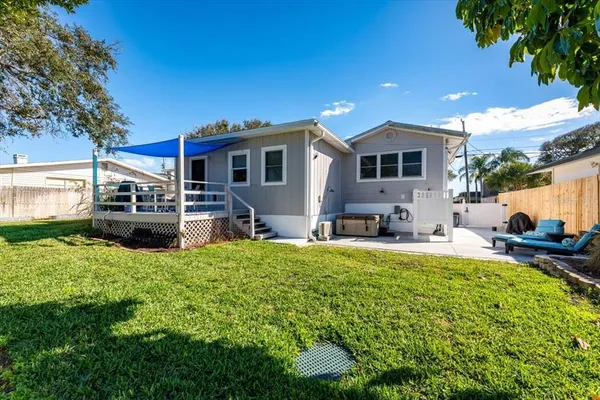 a house view with a sitting space and garden space