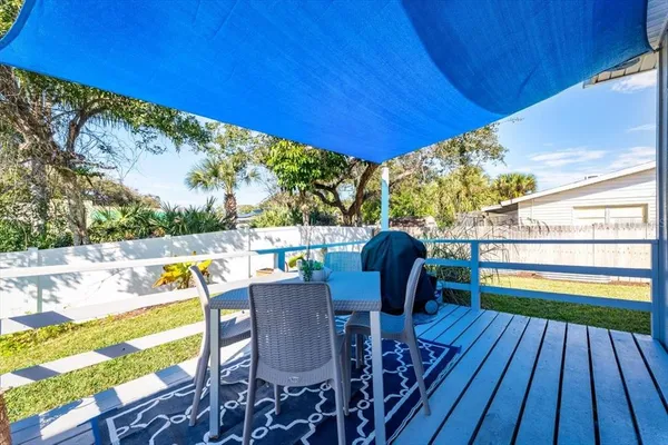 a view of deck with table and chairs and wooden floor