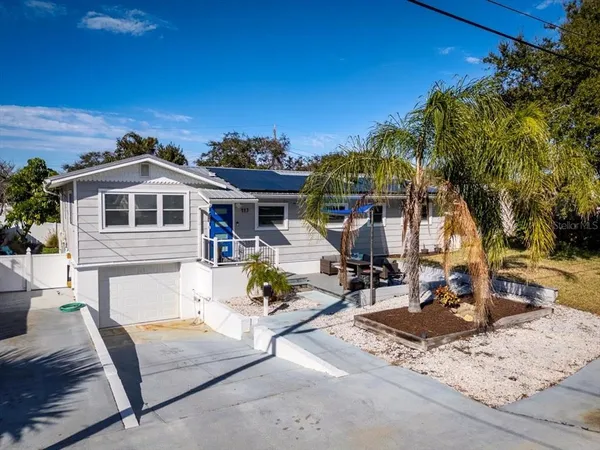 a front view of a house with a garden