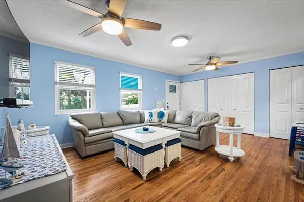 a living room with furniture and wooden floor