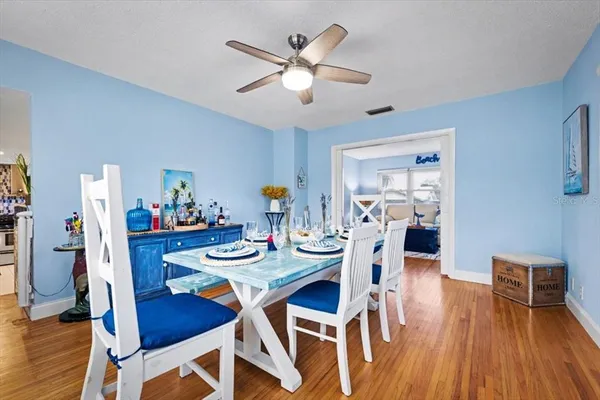 a dining room with furniture and wooden floor