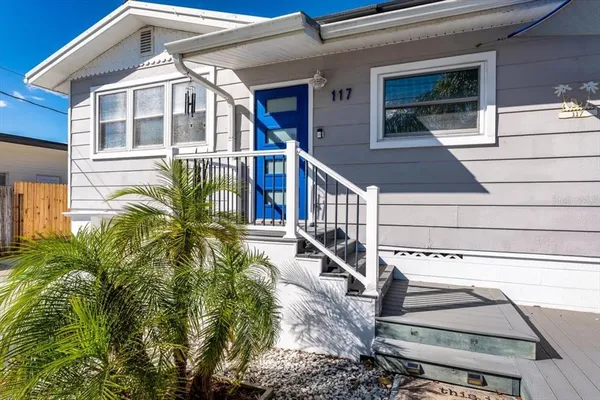 a view of a house with a small yard and plants